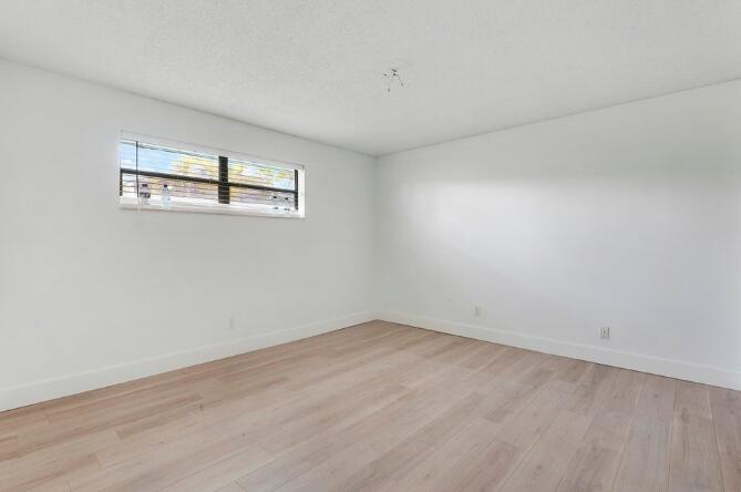 360 Wilma Circle, Unit 7 Riviera Beach, FL 33404 - Photo 11 of 15 wooden floor in a empty room