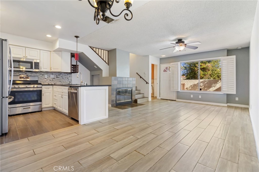12411 Osborne Street, Unit 2 Pacoima, CA 91331 - Photo 12 of 37 a open kitchen with stainless steel appliances granite countertop a stove and a wooden floors