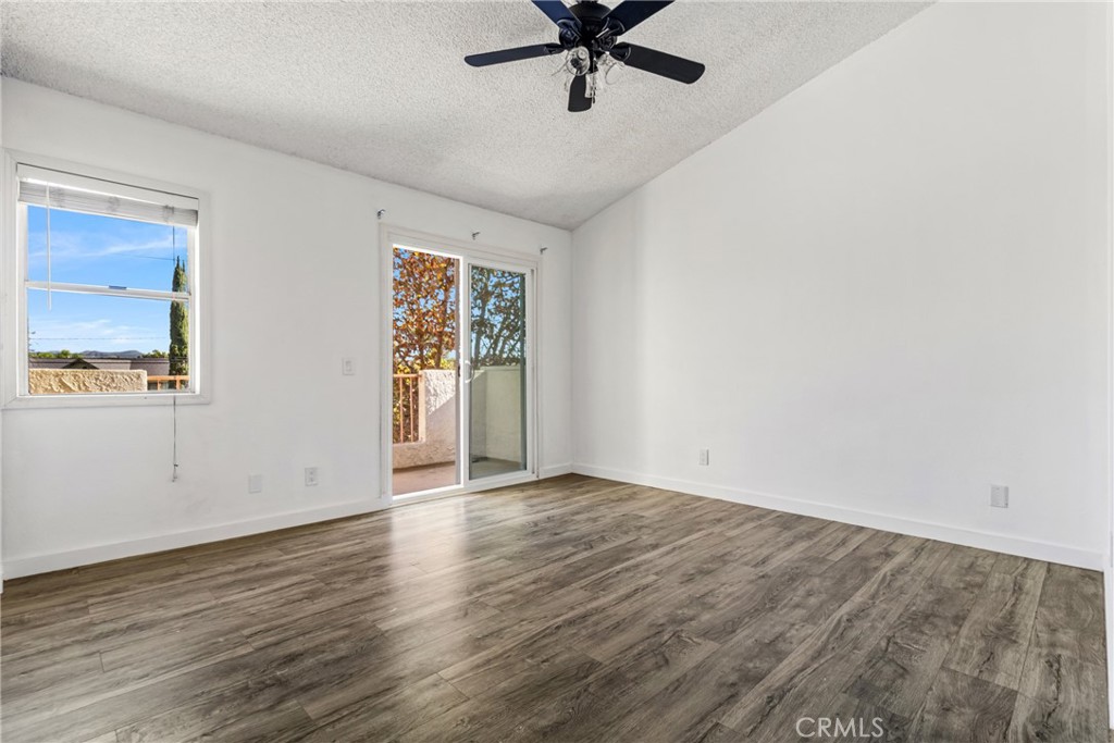 12411 Osborne Street, Unit 2 Pacoima, CA 91331 - Photo 16 of 37 an empty room with wooden floor and windows
