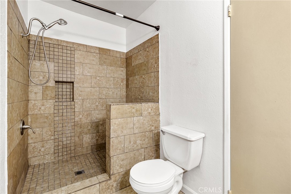 12411 Osborne Street, Unit 2 Pacoima, CA 91331 - Photo 21 of 37 a white toilet sitting next to a bathroom sink