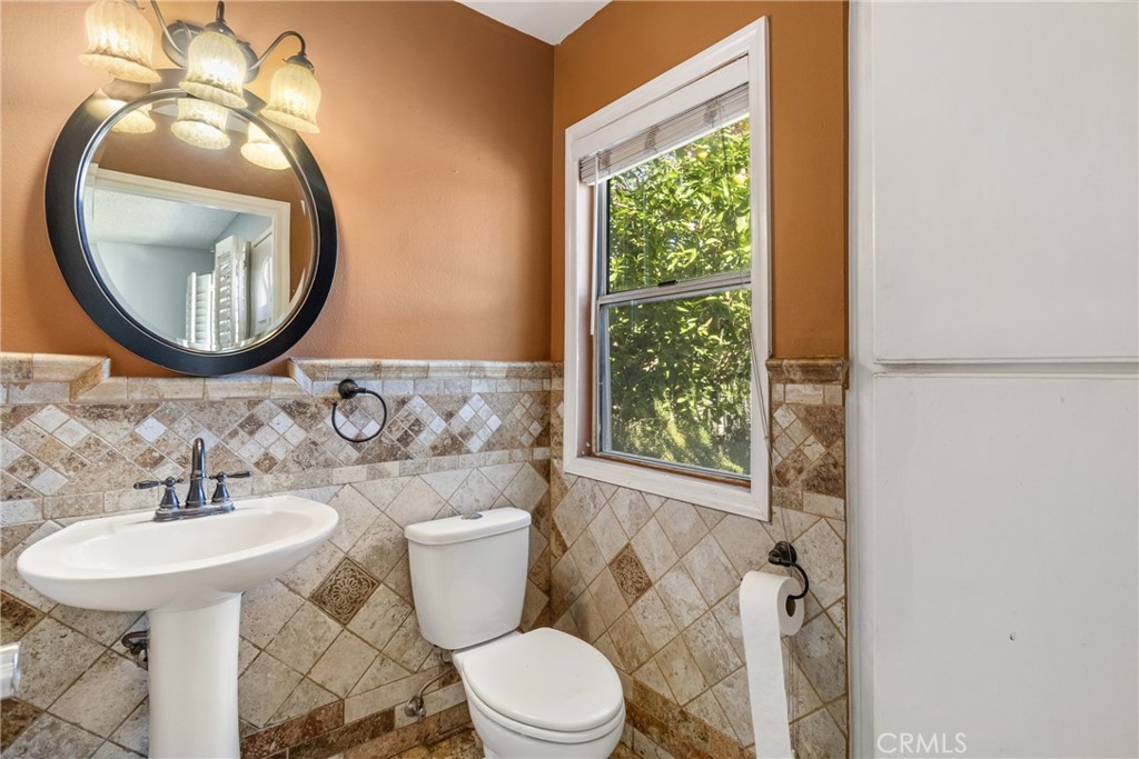 12411 Osborne Street, Unit 2 Pacoima, CA 91331 - Photo 27 of 37 a bathroom with a toilet sink and mirror