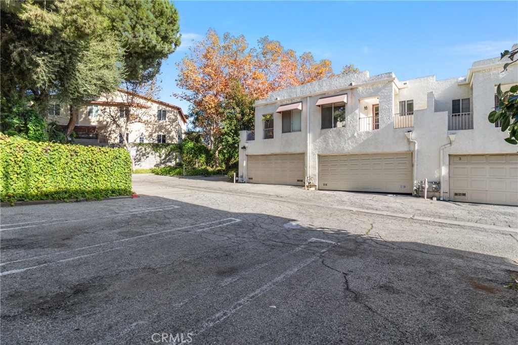 12411 Osborne Street, Unit 2 Pacoima, CA 91331 - Photo 30 of 37 a view of a house with a yard and garage