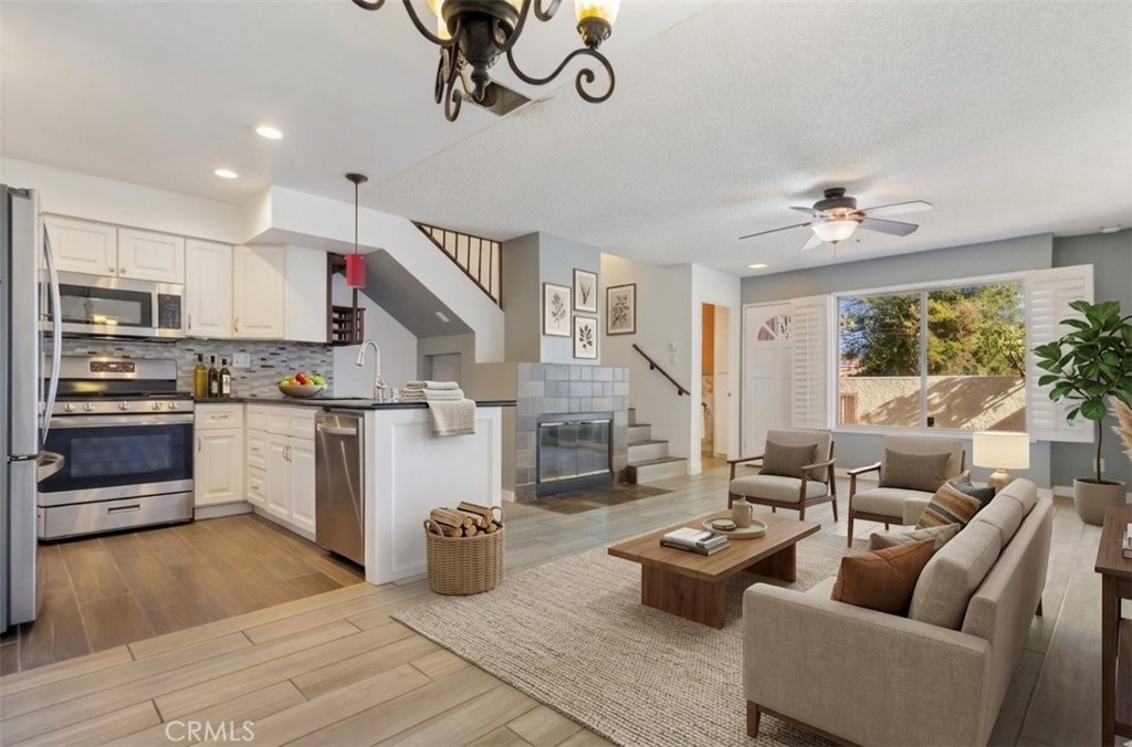12411 Osborne Street, Unit 2 Pacoima, CA 91331 - Photo 3 of 37 a living room with furniture fireplace and kitchen view
