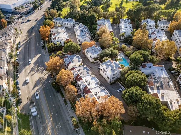an aerial view of a house with a yard and garden