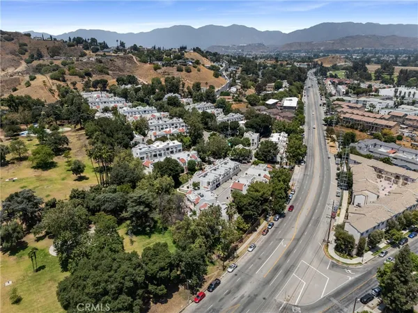 an aerial view of residential houses with outdoor space