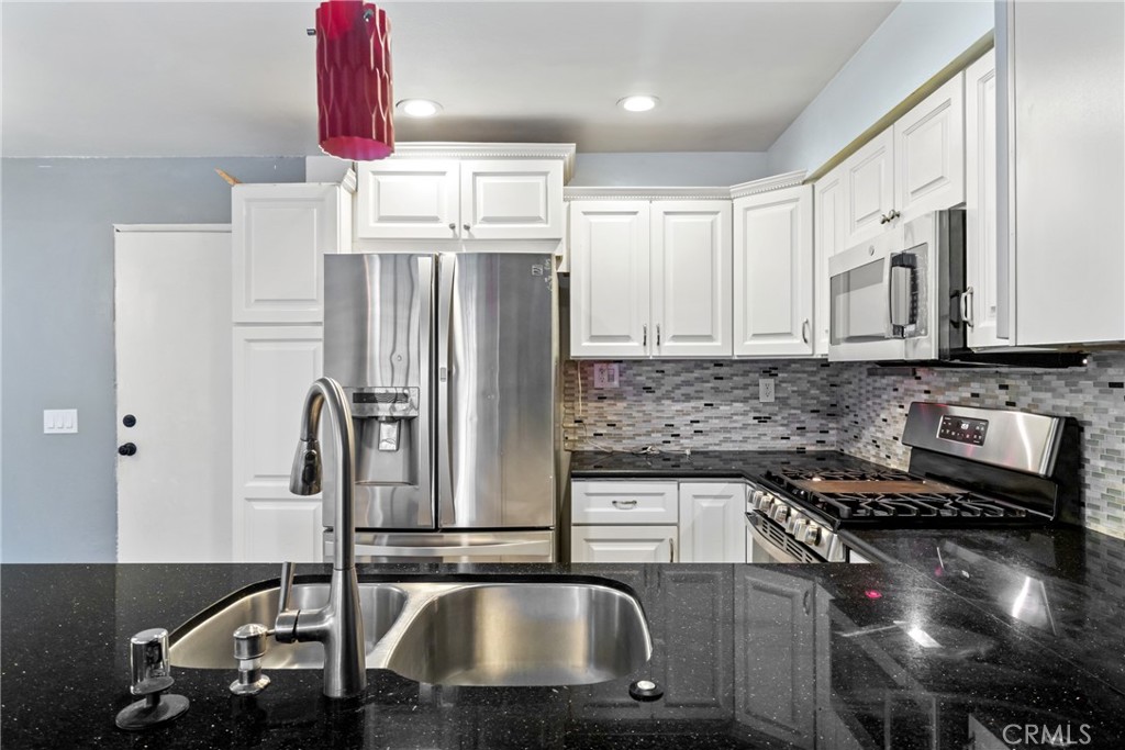 12411 Osborne Street, Unit 2 Pacoima, CA 91331 - Photo 7 of 37 a kitchen with stainless steel appliances granite countertop a sink stove and refrigerator