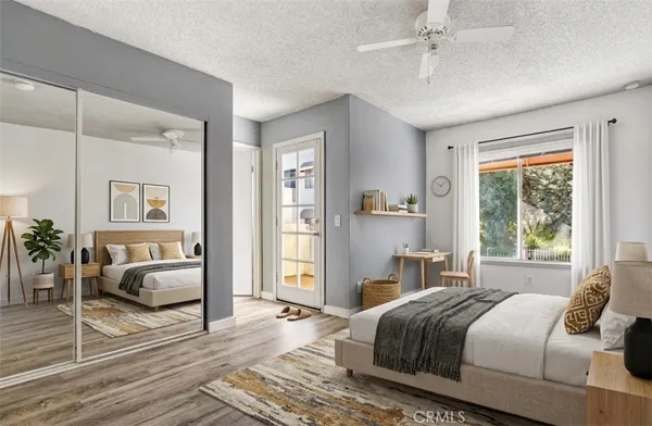 a kitchen with stainless steel appliances kitchen island granite countertop a refrigerator oven a stove and a sink with wooden floor