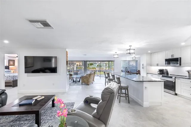 a kitchen with stove a sink and cabinets