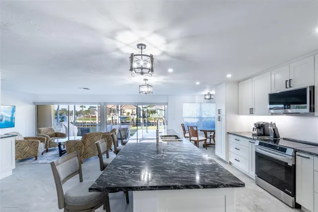 a kitchen with stainless steel appliances a refrigerator sink and stove