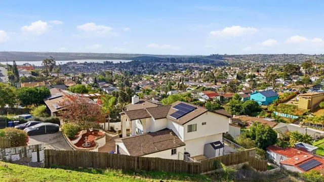 an aerial view of residential house with outdoor space and trees all around