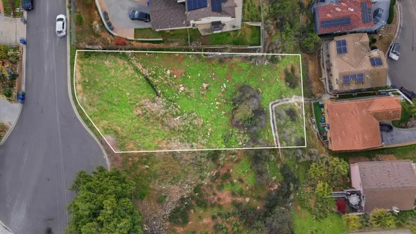 an aerial view of residential houses with outdoor space and swimming pool