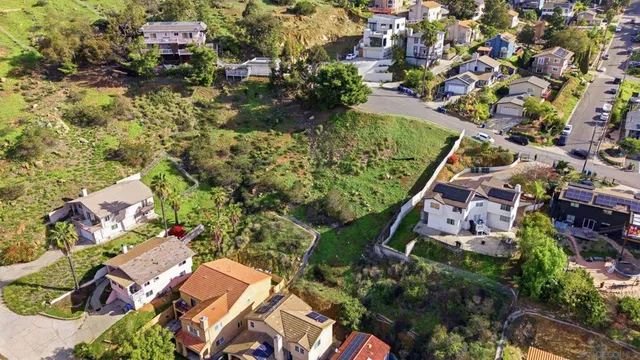 an aerial view of residential houses with outdoor space