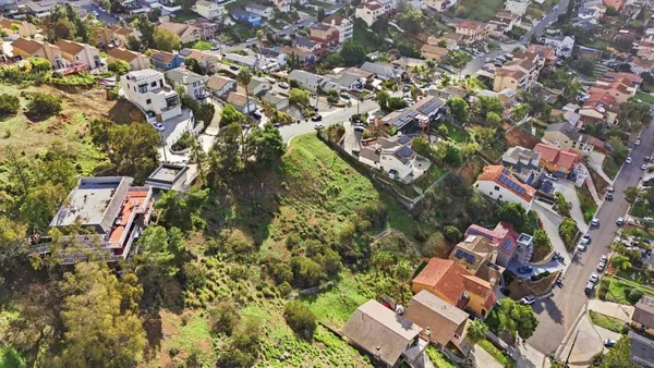 an aerial view of residential houses with outdoor space