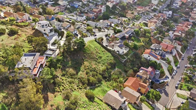 an aerial view of residential houses with outdoor space