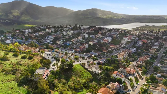 a view of a town with mountains in the background