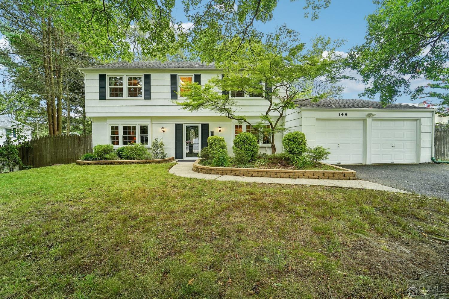 149 Lloyd Road Matawan, NJ 07747 - Photo 1 of 2 a front view of a house with a yard and garage