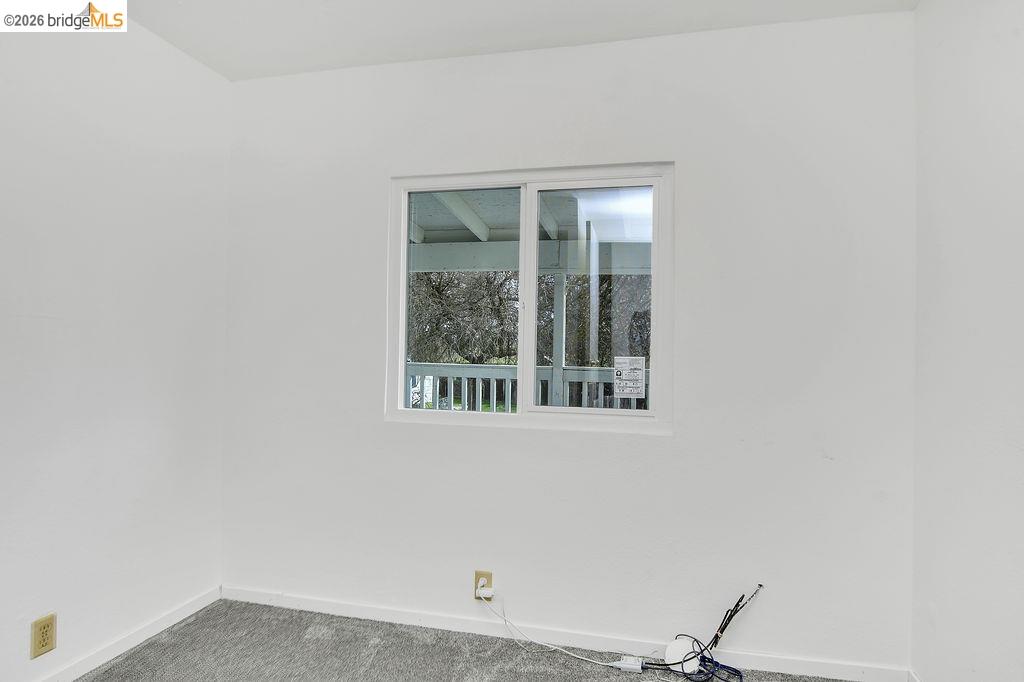 7550 Adams Road Valley Springs, CA 95252 - Photo 17 of 38 Spare room with carpet and baseboards