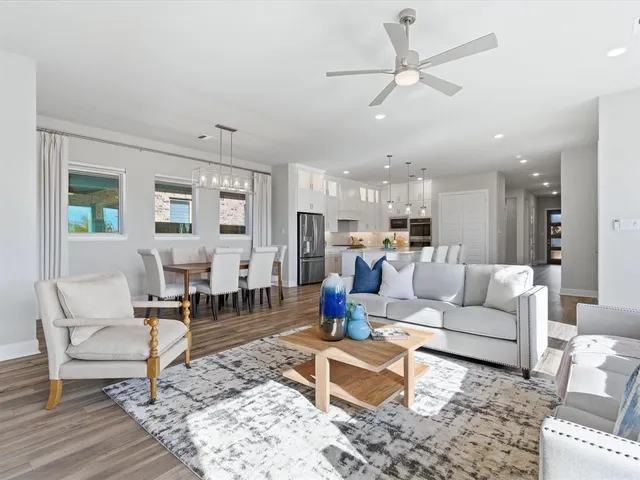 a living room with furniture kitchen view and a table