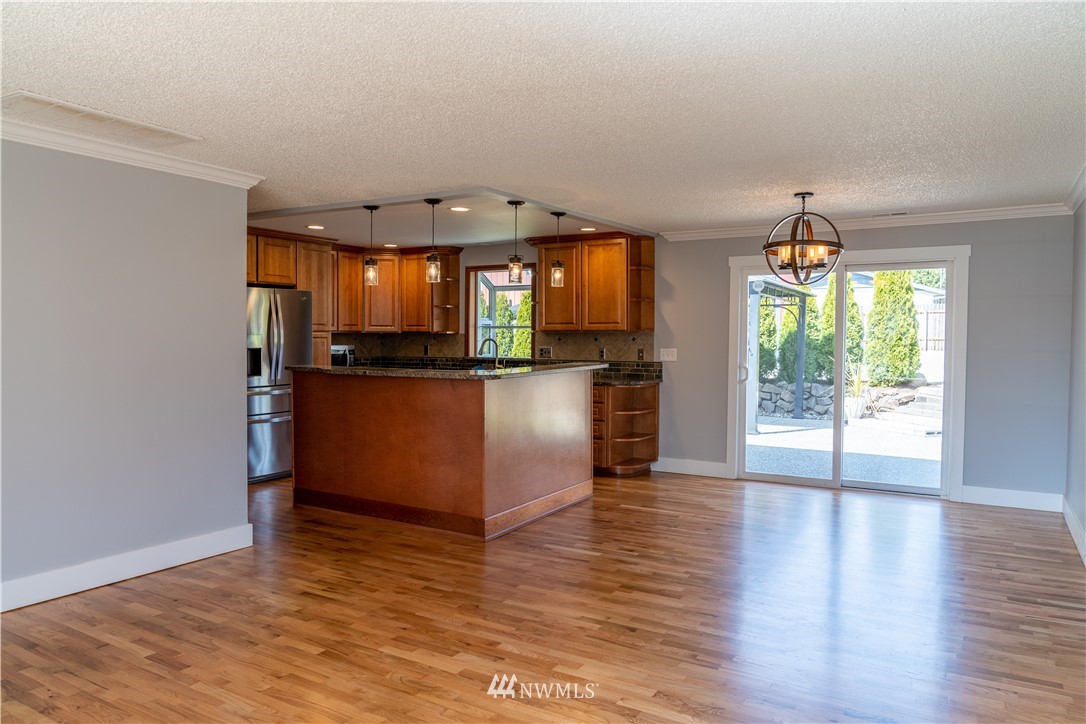 407 216th Street Southwest Bothell, WA 98021 - Photo 3 of 18 an empty room with wooden floor and windows