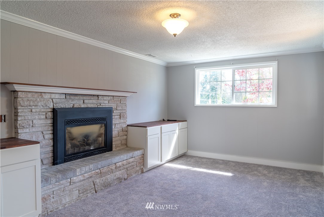 407 216th Street Southwest Bothell, WA 98021 - Photo 5 of 18 a room with a fireplace and a window