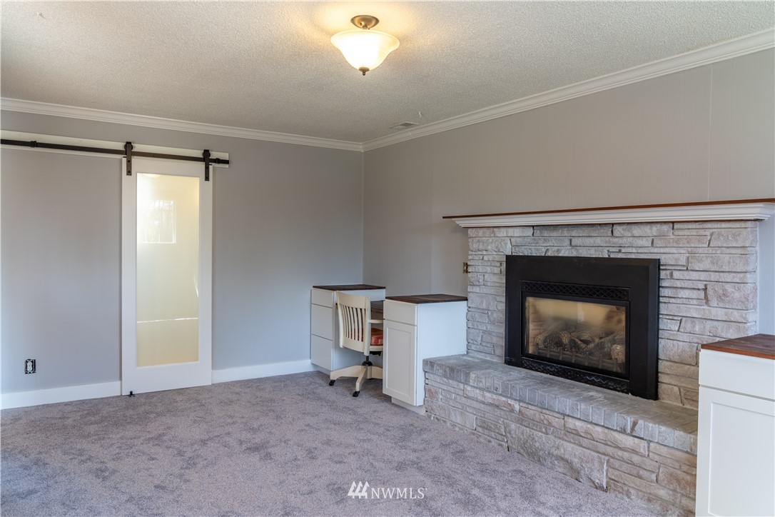 407 216th Street Southwest Bothell, WA 98021 - Photo 6 of 18 a living room with furniture and a fireplace