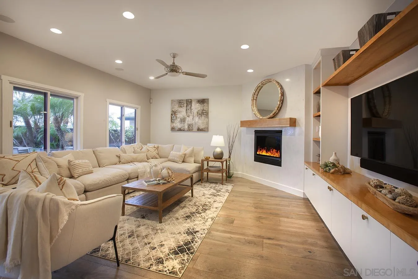 13497 Calais Drive Del Mar, CA 92014 - Photo 13 of 22 a living room with furniture a window and a fireplace