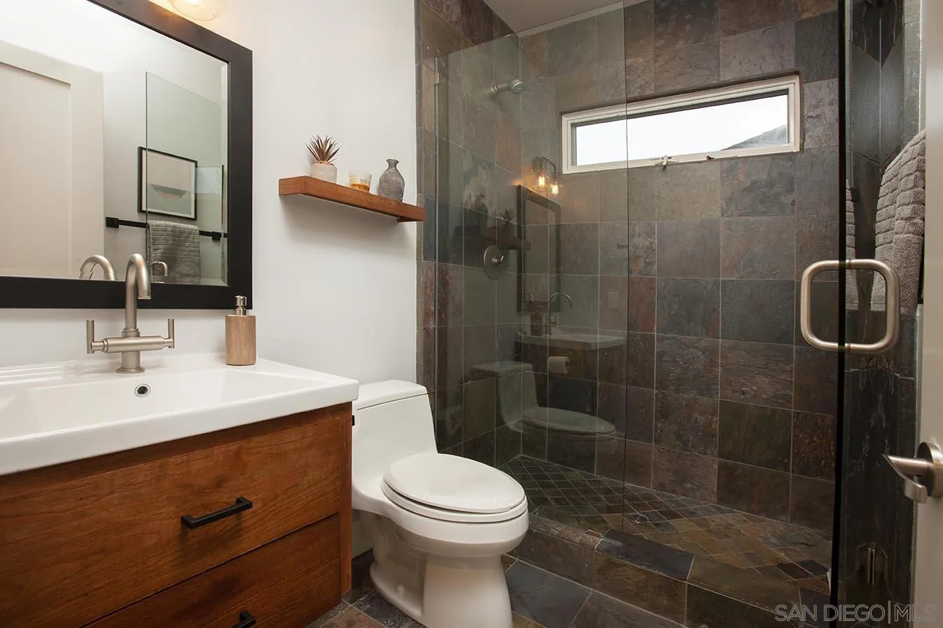 13497 Calais Drive Del Mar, CA 92014 - Photo 19 of 22 a bathroom with a sink a toilet and shower