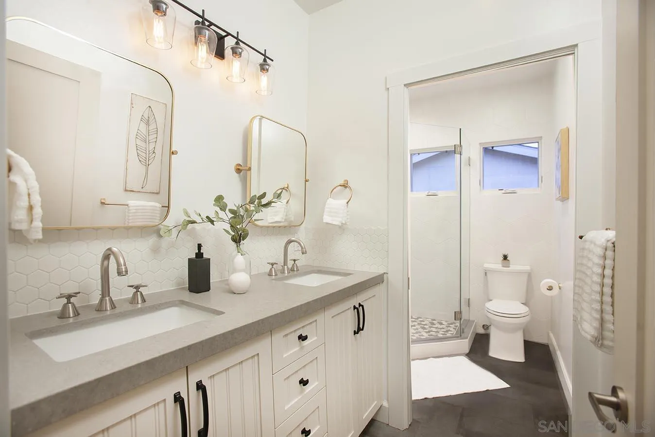 13497 Calais Drive Del Mar, CA 92014 - Photo 21 of 22 a bathroom with a sink a toilet and a mirror