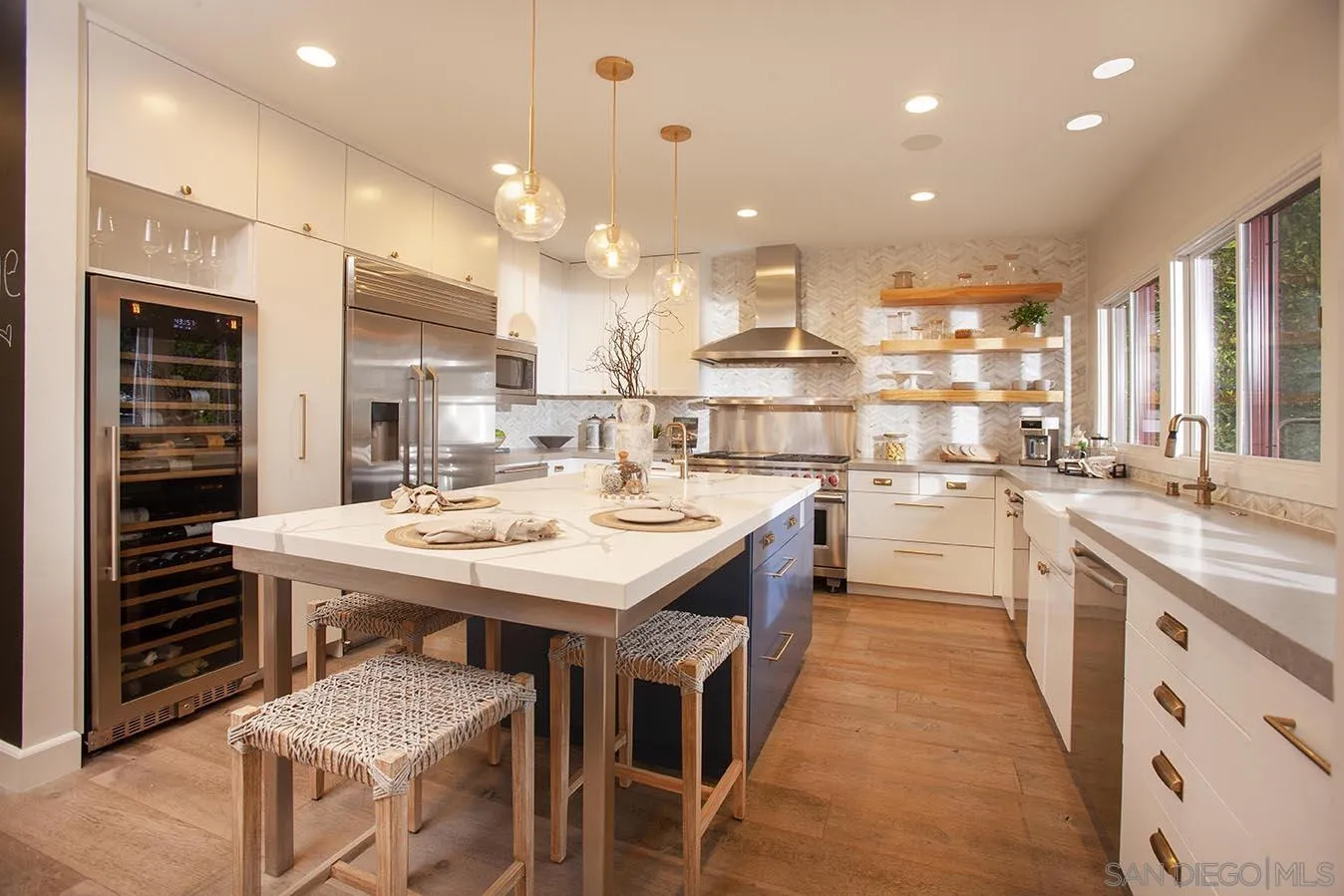 13497 Calais Drive Del Mar, CA 92014 - Photo 8 of 22 a open kitchen with kitchen island a sink a stove and a refrigerator