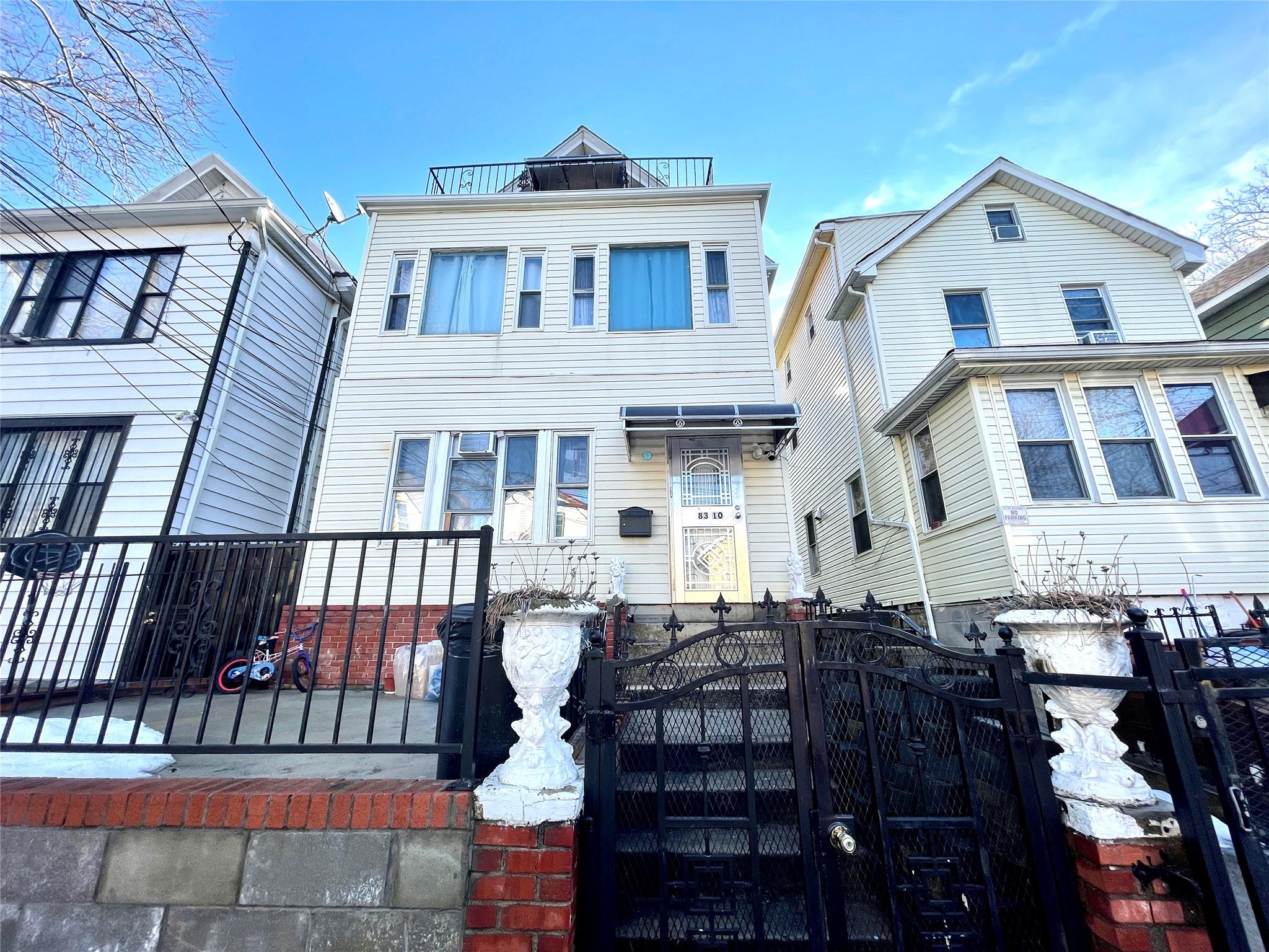 View of front of house with a fenced front yard and a gate
