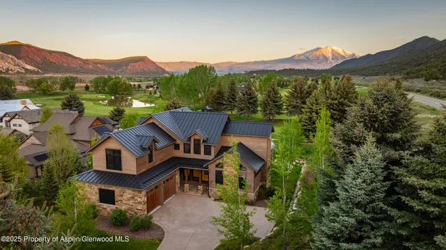 a view of a house with a snow on the road