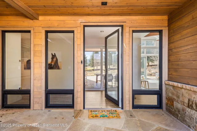 a view of a house with a yard porch and furniture