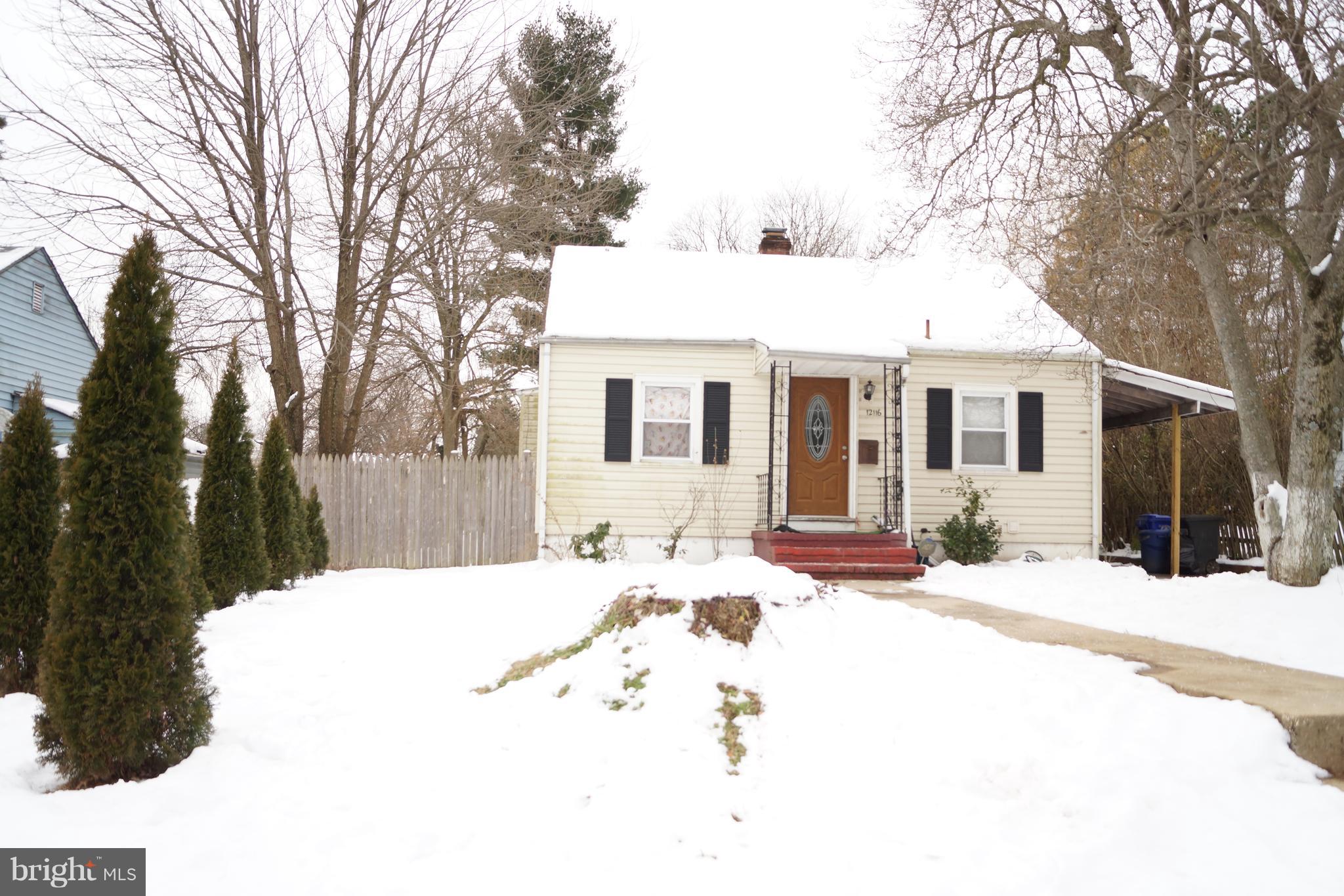12116 Veirs Mill Road Silver Spring, MD 20906 - Photo 1 of 10 a view of a white house with a snow on the road