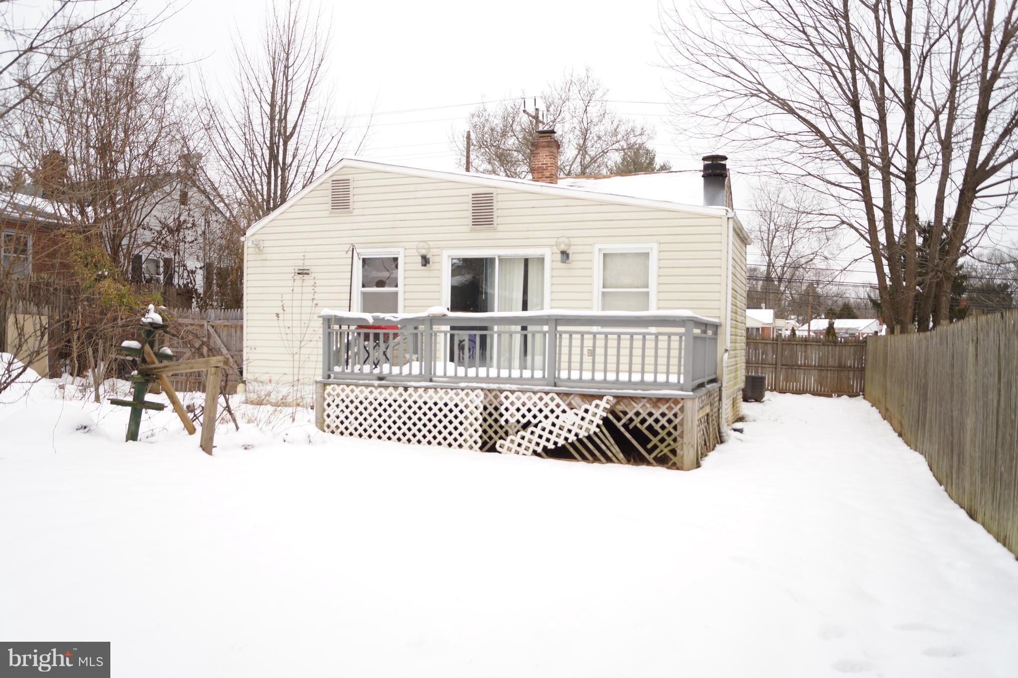 12116 Veirs Mill Road Silver Spring, MD 20906 - Photo 2 of 10 a view of a house with a yard covered in snow