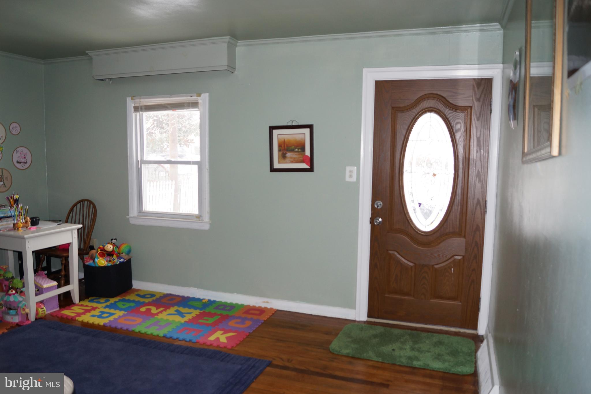 12116 Veirs Mill Road Silver Spring, MD 20906 - Photo 7 of 10 a view of entryway with wooden floor and a window