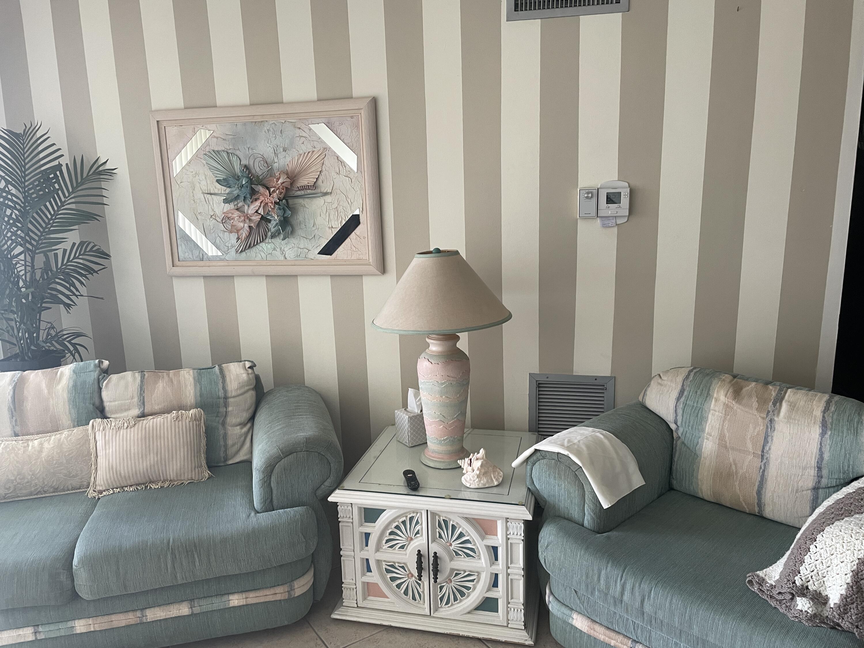 506 Davis Road, Unit 78 Palm Springs, FL 33461 - Photo 12 of 58 a living room with furniture and a painting on the wall