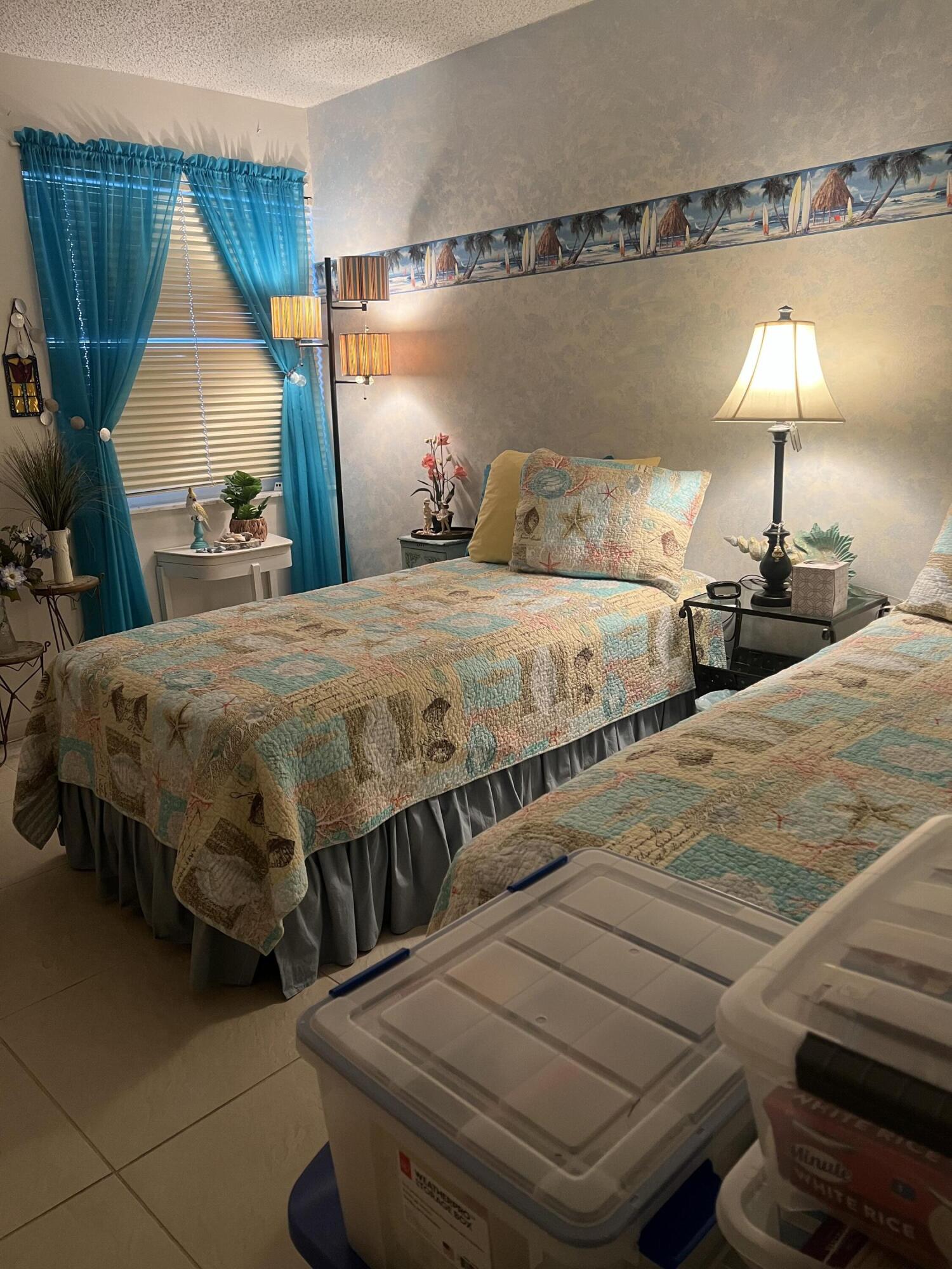 506 Davis Road, Unit 78 Palm Springs, FL 33461 - Photo 14 of 58 a bedroom with bed and a night stand