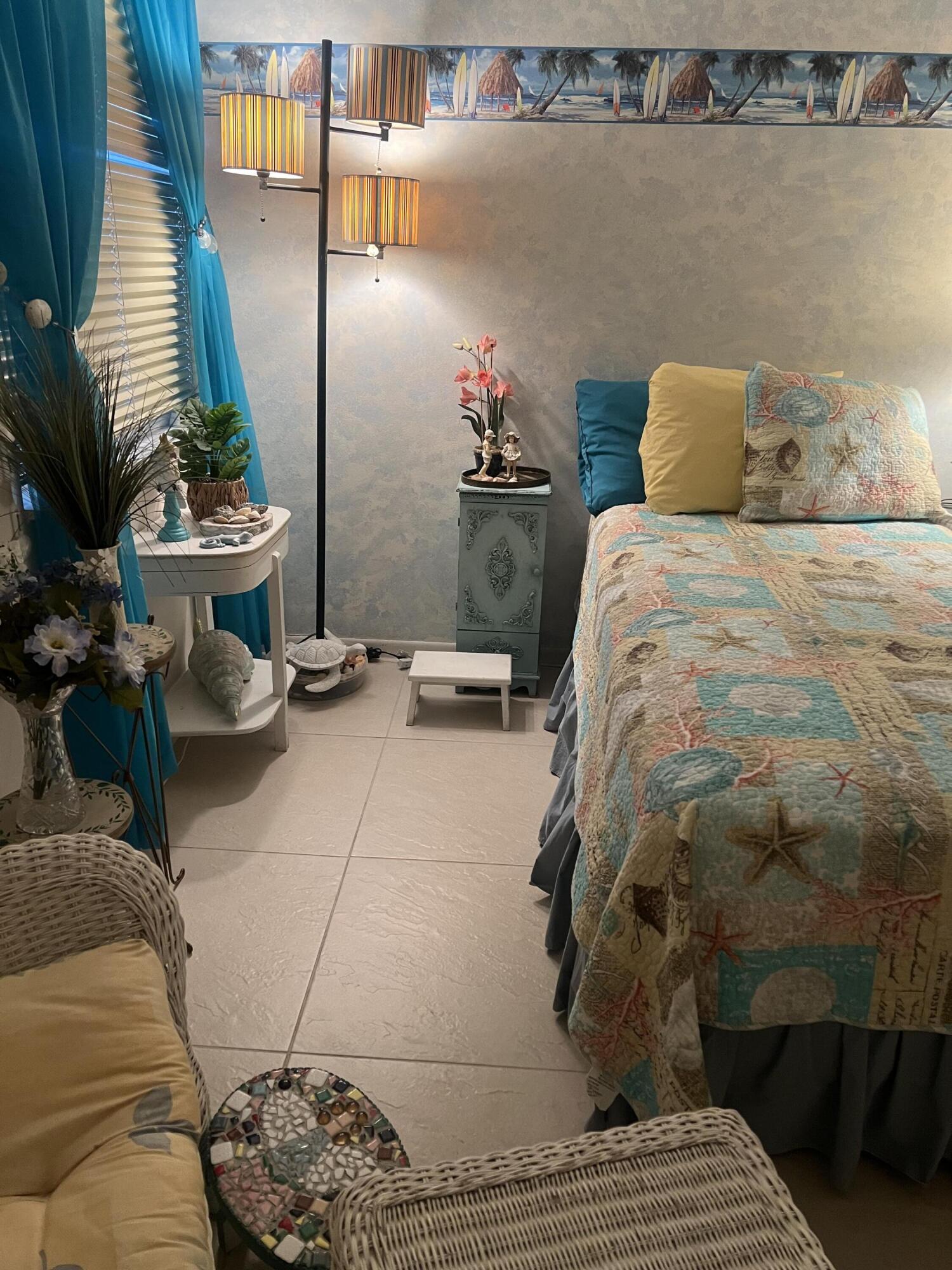 506 Davis Road, Unit 78 Palm Springs, FL 33461 - Photo 16 of 58 a bedroom with a bed and a potted plant