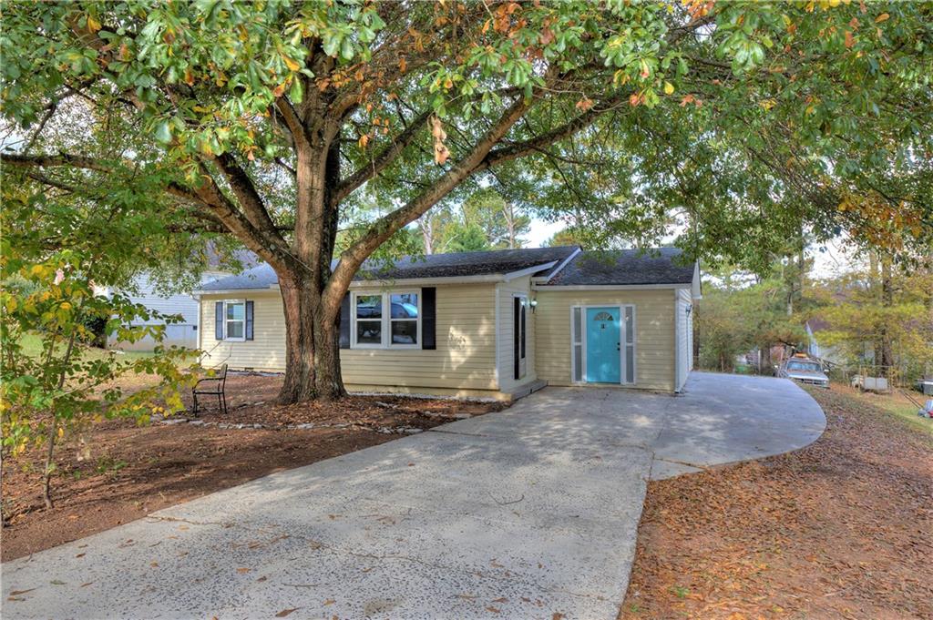 a view of a house with a tree in front of it