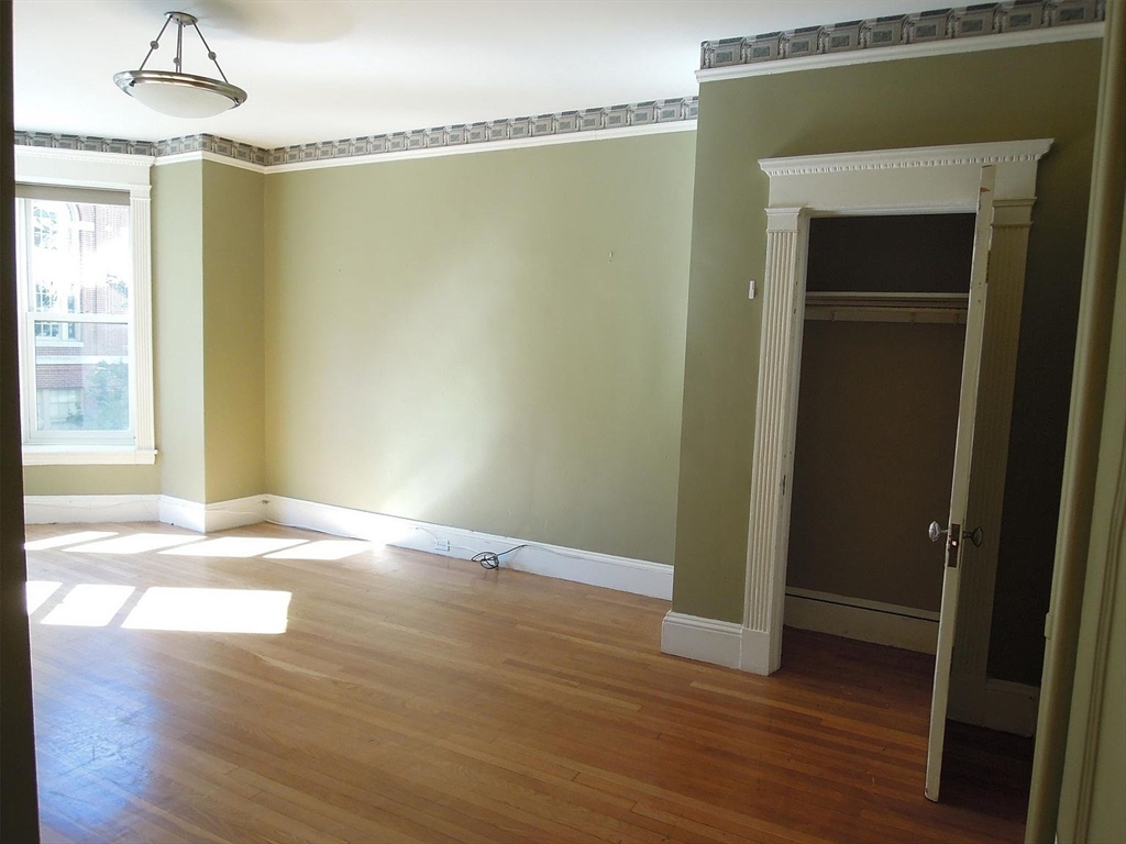 8 Garrison Street, Unit 209 Boston, MA 02116 - Photo 10 of 33 a view of empty room with wooden floor and fan