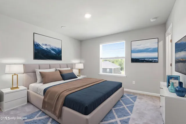 a bedroom with a large bed and a window