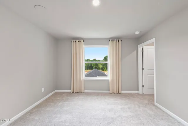 an empty room with an outdoor view and a window