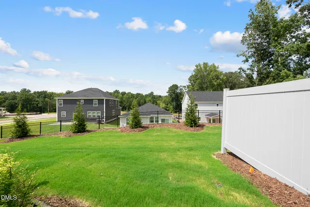a view of a house with a yard and sitting area