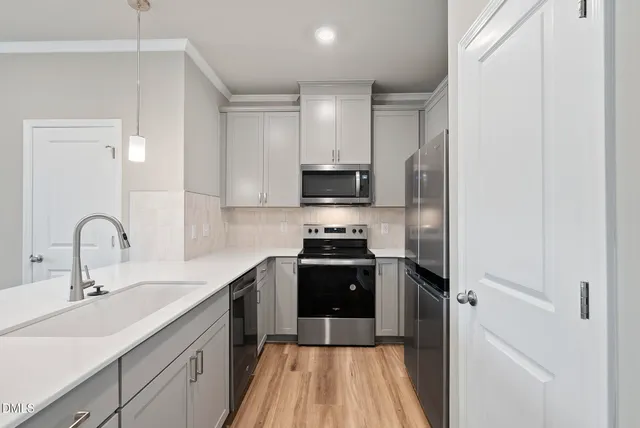 a kitchen with a sink appliances and cabinets