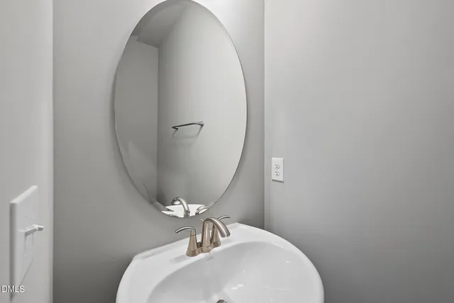 a bathroom with a sink and mirror