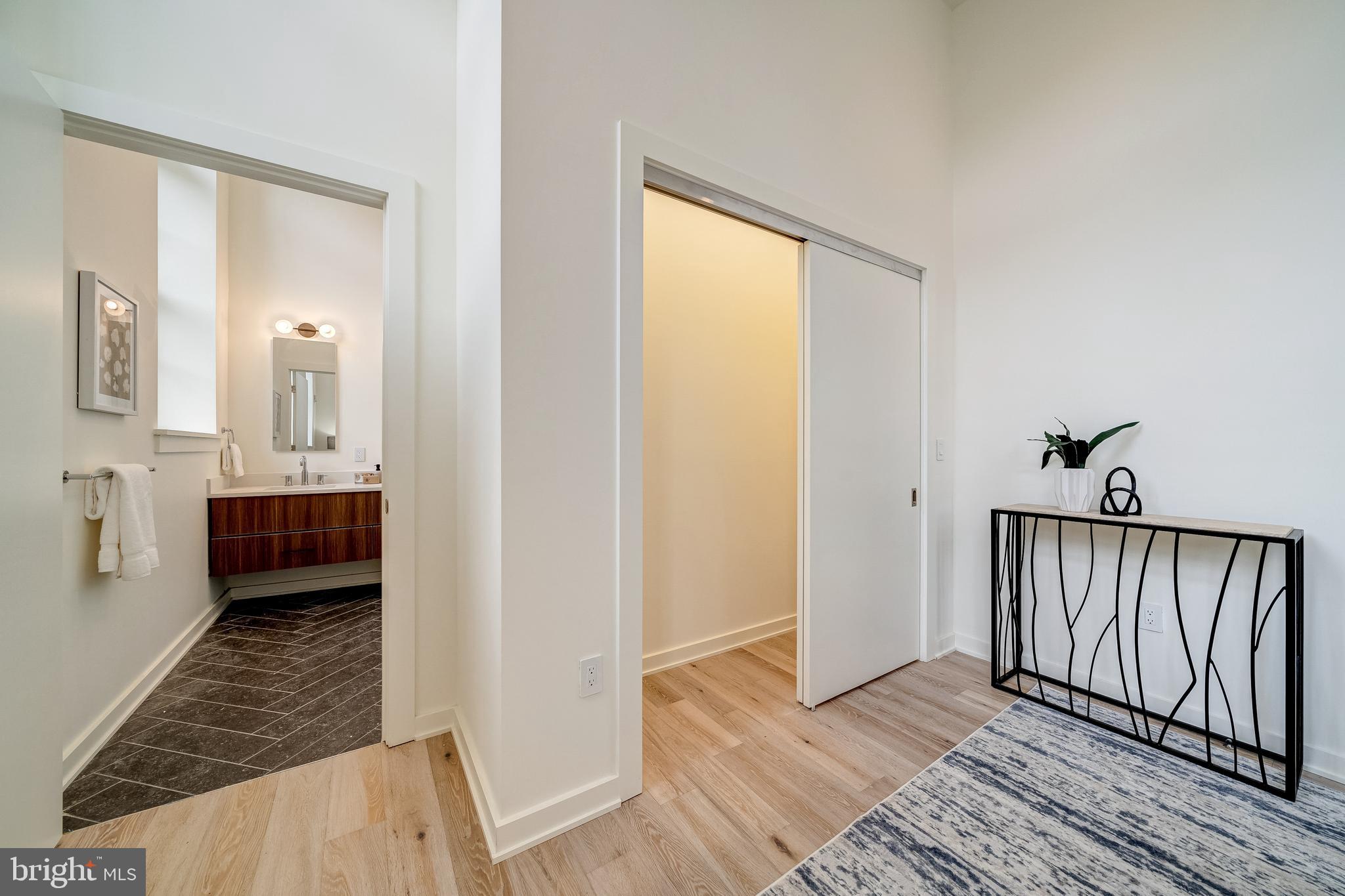 440 R Street Northwest, Unit 103 Washington, DC 20001 - Photo 11 of 22 Primary closet and ensuite bathroom