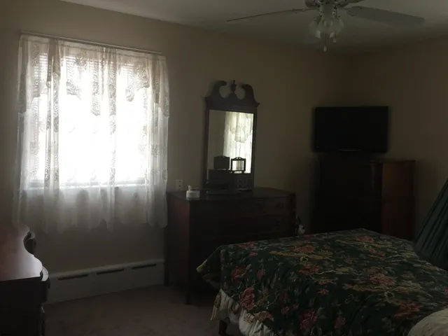a bedroom with a bed and a window