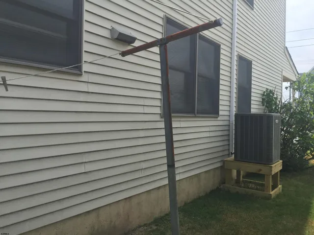 a view of a yard with wooden fence