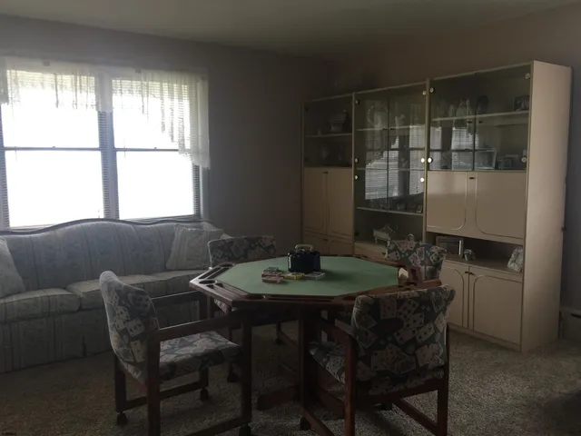 a dining room with furniture and window