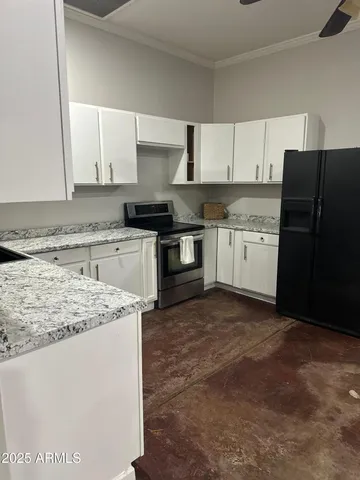 a kitchen with stainless steel appliances granite countertop a stove a sink and a refrigerator